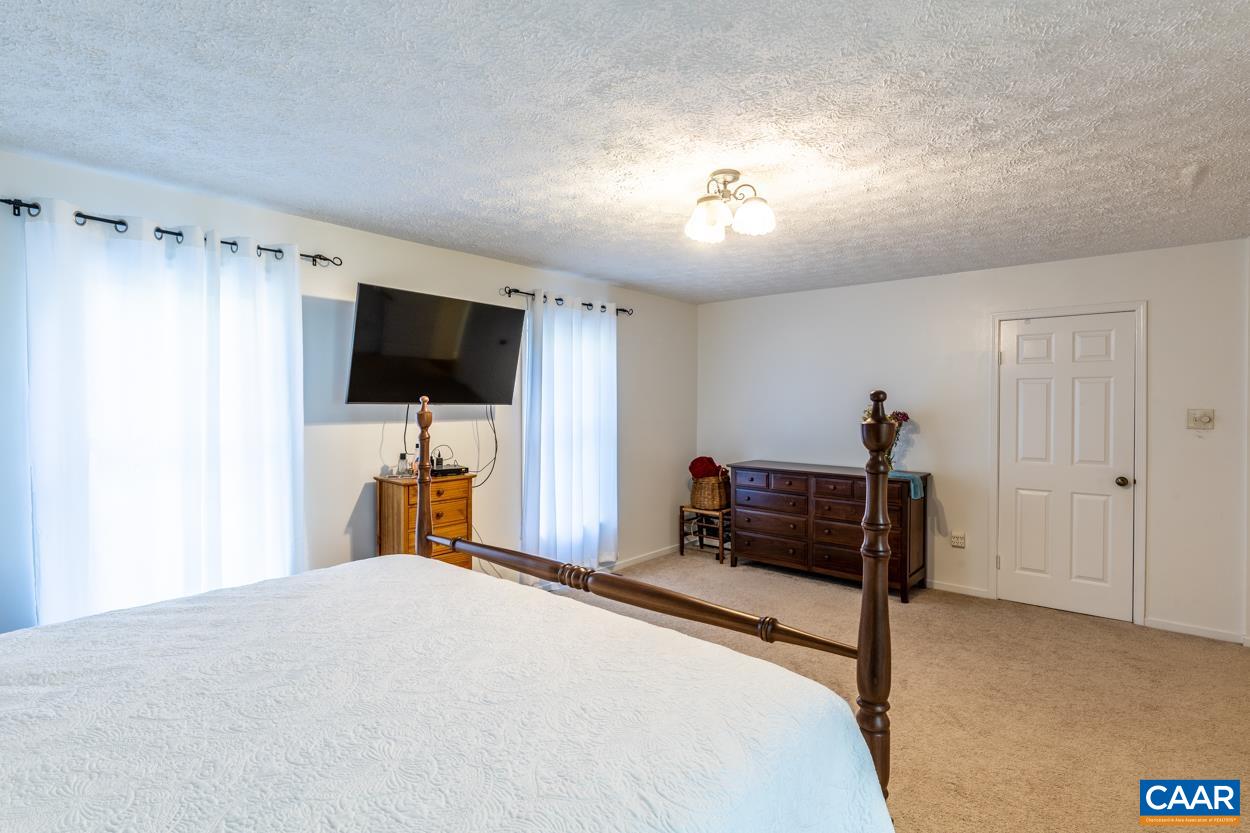 435 Courthouse Mountain Road Madison, VA 22727 - Photo 48 of 69 a bedroom with a bed and a flat screen tv