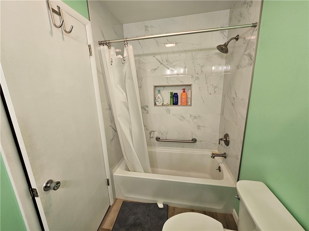 3998 Willowcrest Road Beavercreek, OH 45430 - Photo 20 of 41 This bathroom features a sleek tub and shower combination with stylish tiled walls.