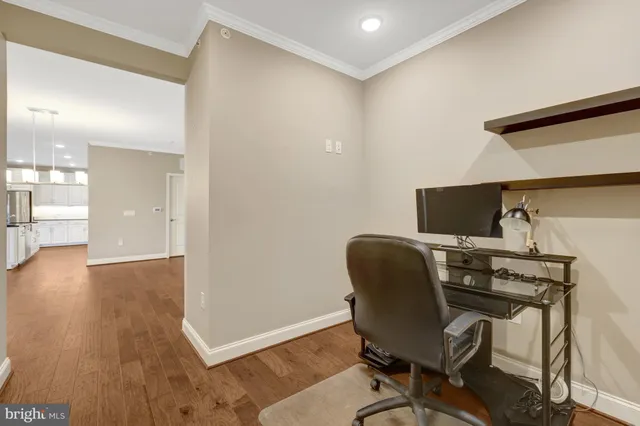 a view of a workspace with furniture and wooden floor