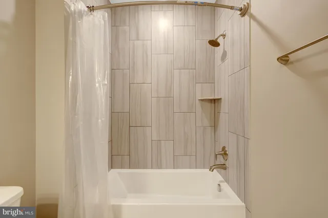 a bathroom with a bath tub and shower curtain