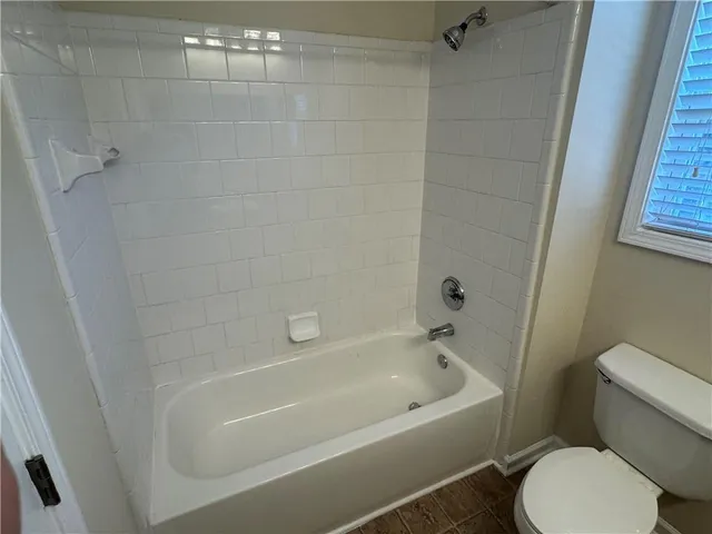 a white bath tub sitting next to a white toilet