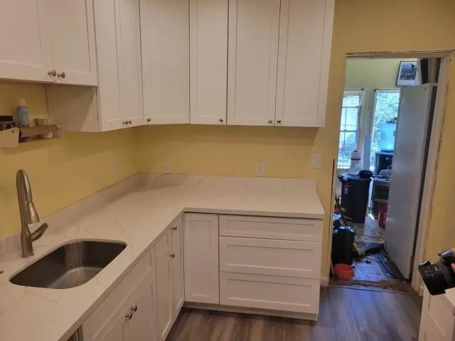 a kitchen with a sink and cabinets