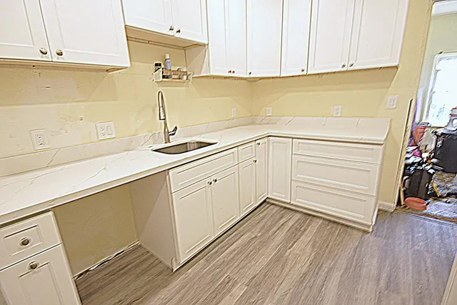 a kitchen with a sink and cabinets