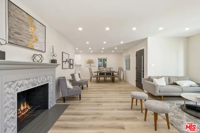 a living room with furniture a fireplace and a table