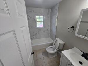 1711 Westover Avenue Southwest, Unit 1 Roanoke, VA 24015 - Photo 6 of 8 a bathroom with a sink a toilet and bathtub