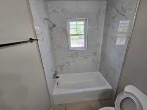 a bathroom with a bathtub and shower
