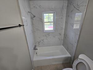 1711 Westover Avenue Southwest, Unit 1 Roanoke, VA 24015 - Photo 7 of 8 a bathroom with a bathtub and shower