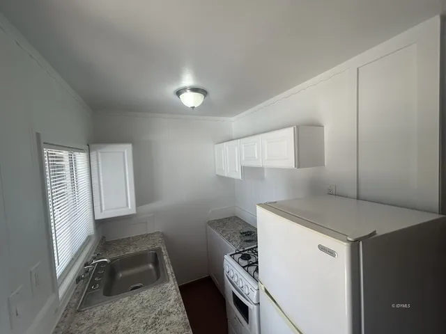 a utility room with cabinets washer and dryer