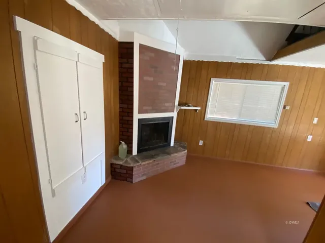 a view of an empty room with a fireplace