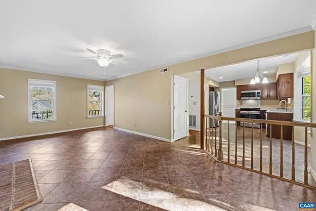 a view of a big room with wooden floor and a bathroom