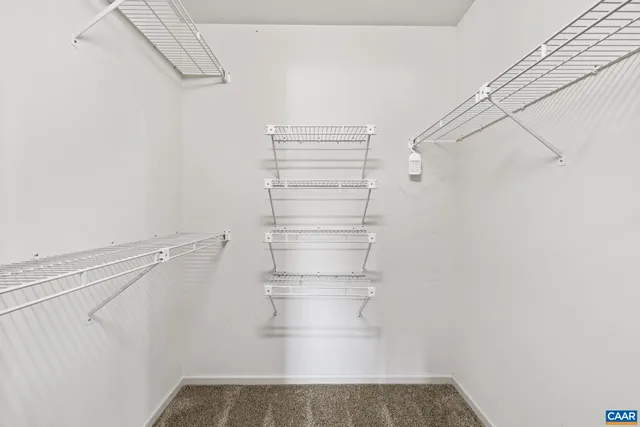 a bathroom with a granite countertop sink toilet and mirror