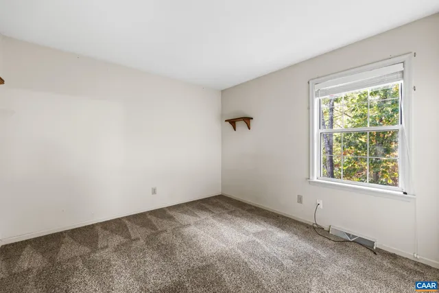 a view of house with a yard and potted plants