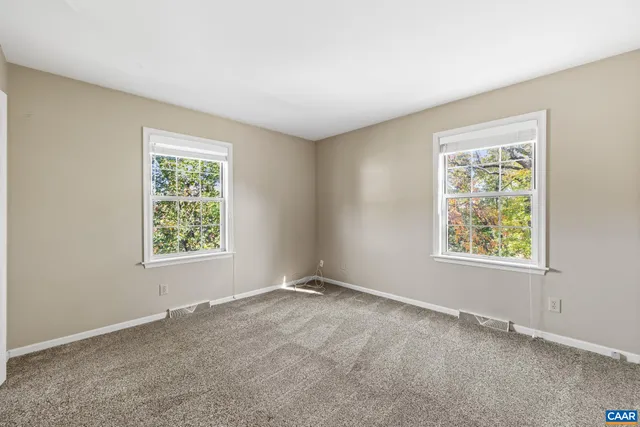 a view of a wooden balcony and trees