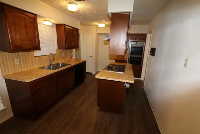 a view of a room with wooden floor and natural light