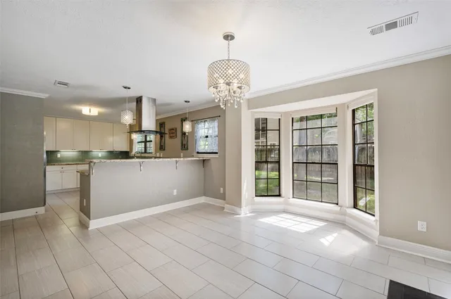 a view of a kitchen with refrigerator and window