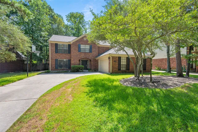 a front view of a house with yard and green space