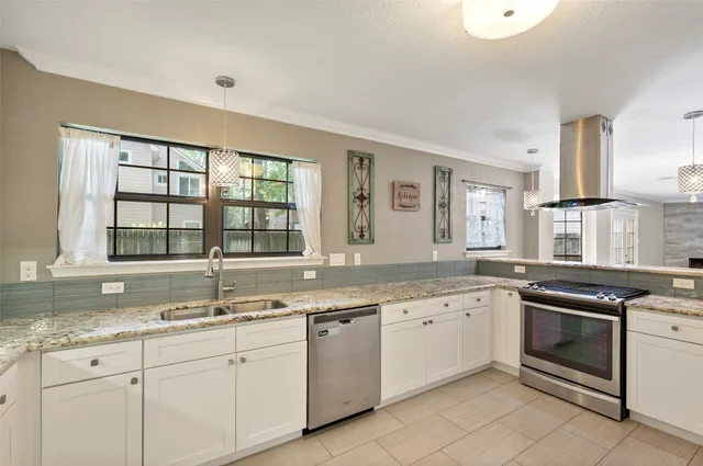 a kitchen with granite countertop sink stainless steel appliances and window