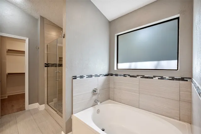 a bathroom with a bathtub and a shower