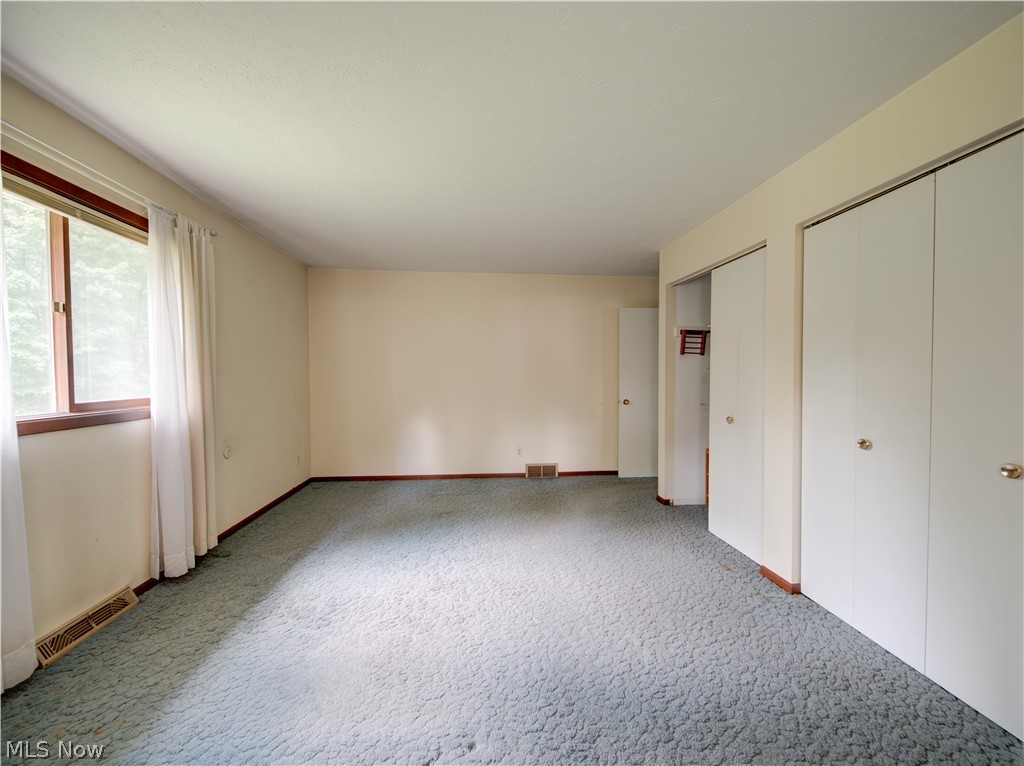 11430 Ferry Road Chesterland, OH 44026 - Photo 21 of 38 Unfurnished bedroom featuring two closets and carpet floors