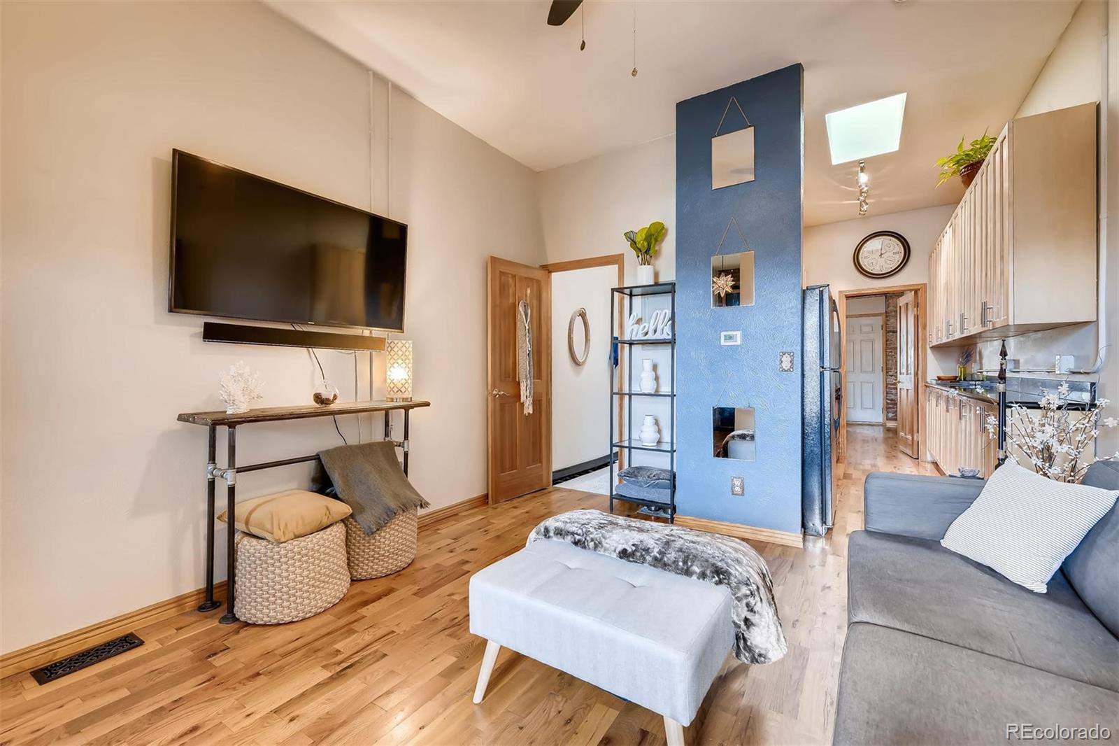 470 Inca Street Denver, CO 80204 - Photo 3 of 11 a living room with furniture and a flat screen tv