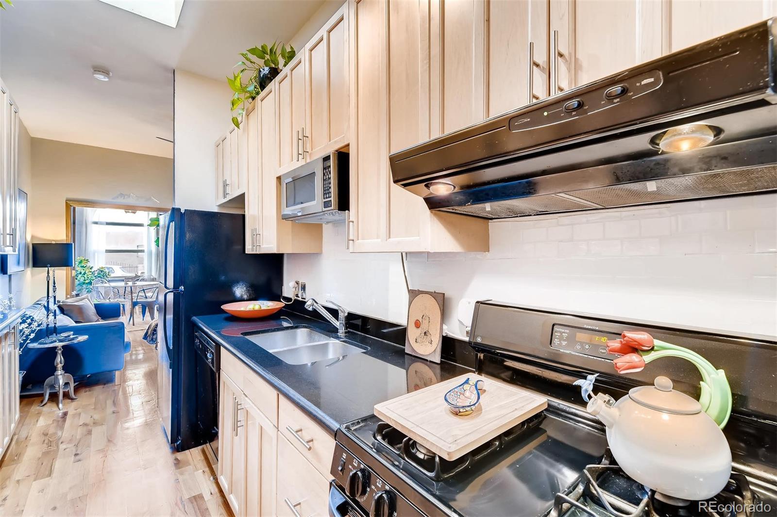 470 Inca Street Denver, CO 80204 - Photo 7 of 11 a kitchen with a stove and a microwave