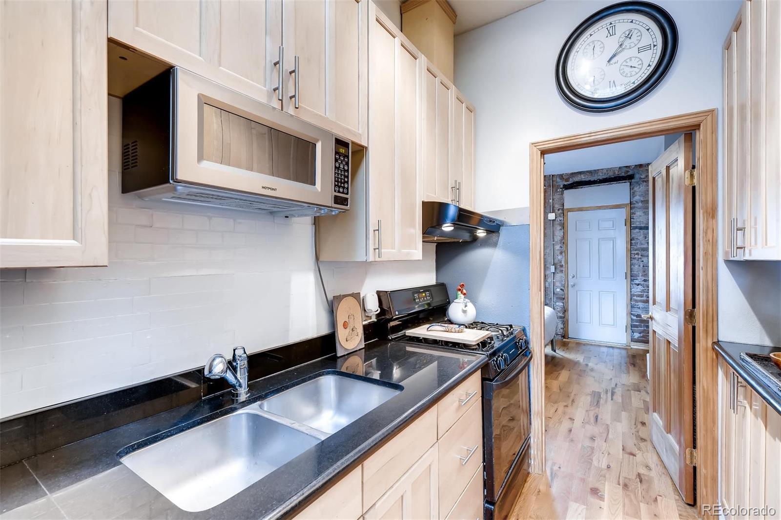 470 Inca Street Denver, CO 80204 - Photo 8 of 11 a kitchen with a sink cabinets and stainless steel appliances