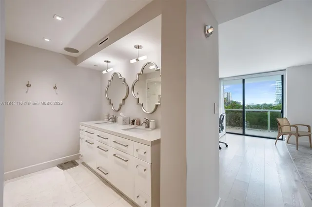 a bathroom with a double vanity sink mirror and shower