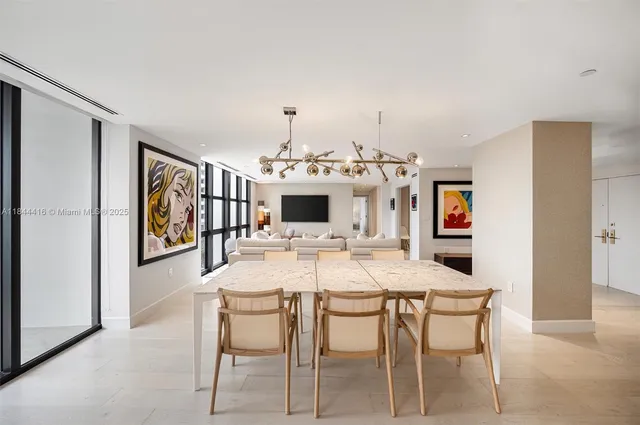 a view of a dining room with furniture and chandelier