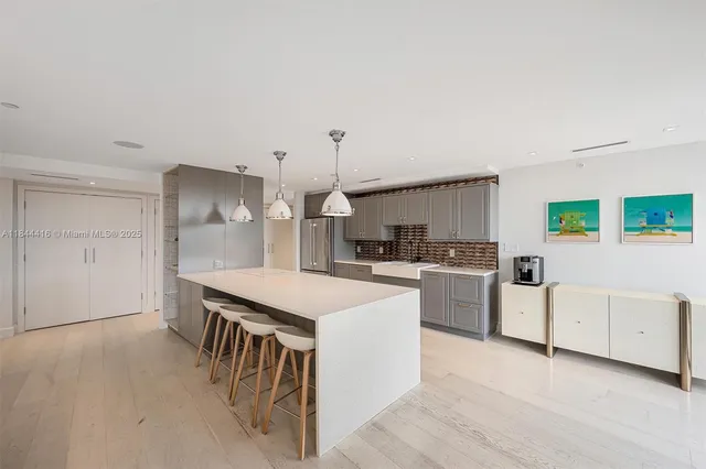 a kitchen with cabinets and wooden floor