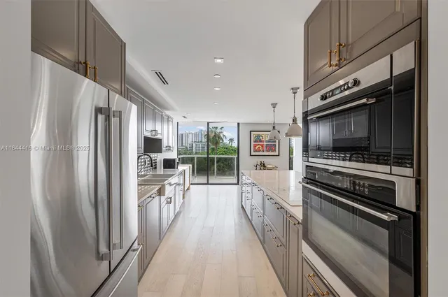 a kitchen with stainless steel appliances a refrigerator and a stove top oven