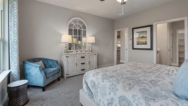 a bedroom with bed and painting on the wall