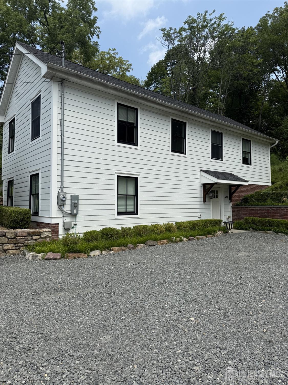 66 Main Street, Unit 3 Peapack, NJ 07977 - Photo 1 of 13 a front view of a house with a yard