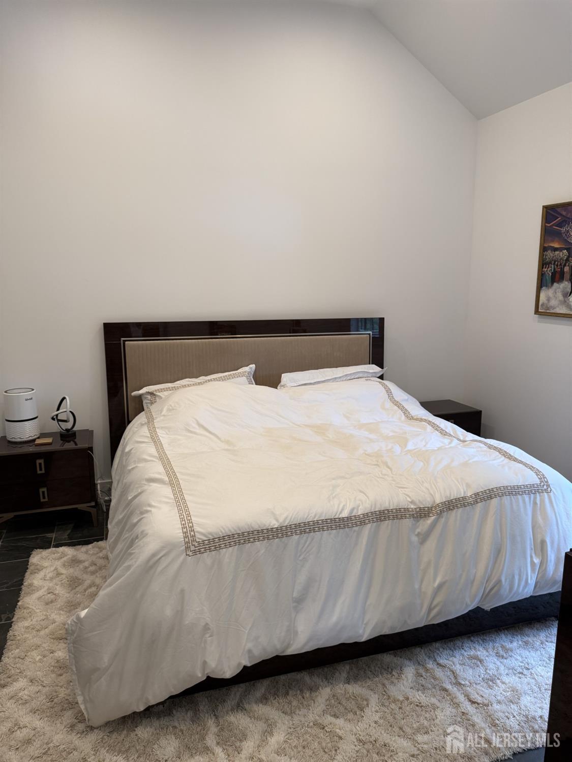 66 Main Street, Unit 3 Peapack, NJ 07977 - Photo 13 of 13 a bed sitting in a bedroom next to a window