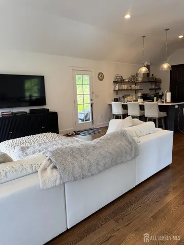 a bedroom with a large bed and a flat screen tv