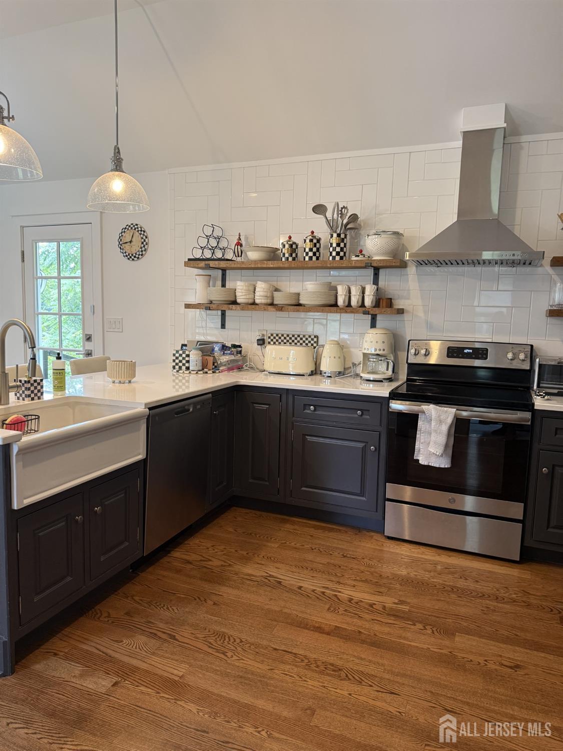 66 Main Street, Unit 3 Peapack, NJ 07977 - Photo 9 of 13 a kitchen with stainless steel appliances granite countertop a stove a sink and a refrigerator