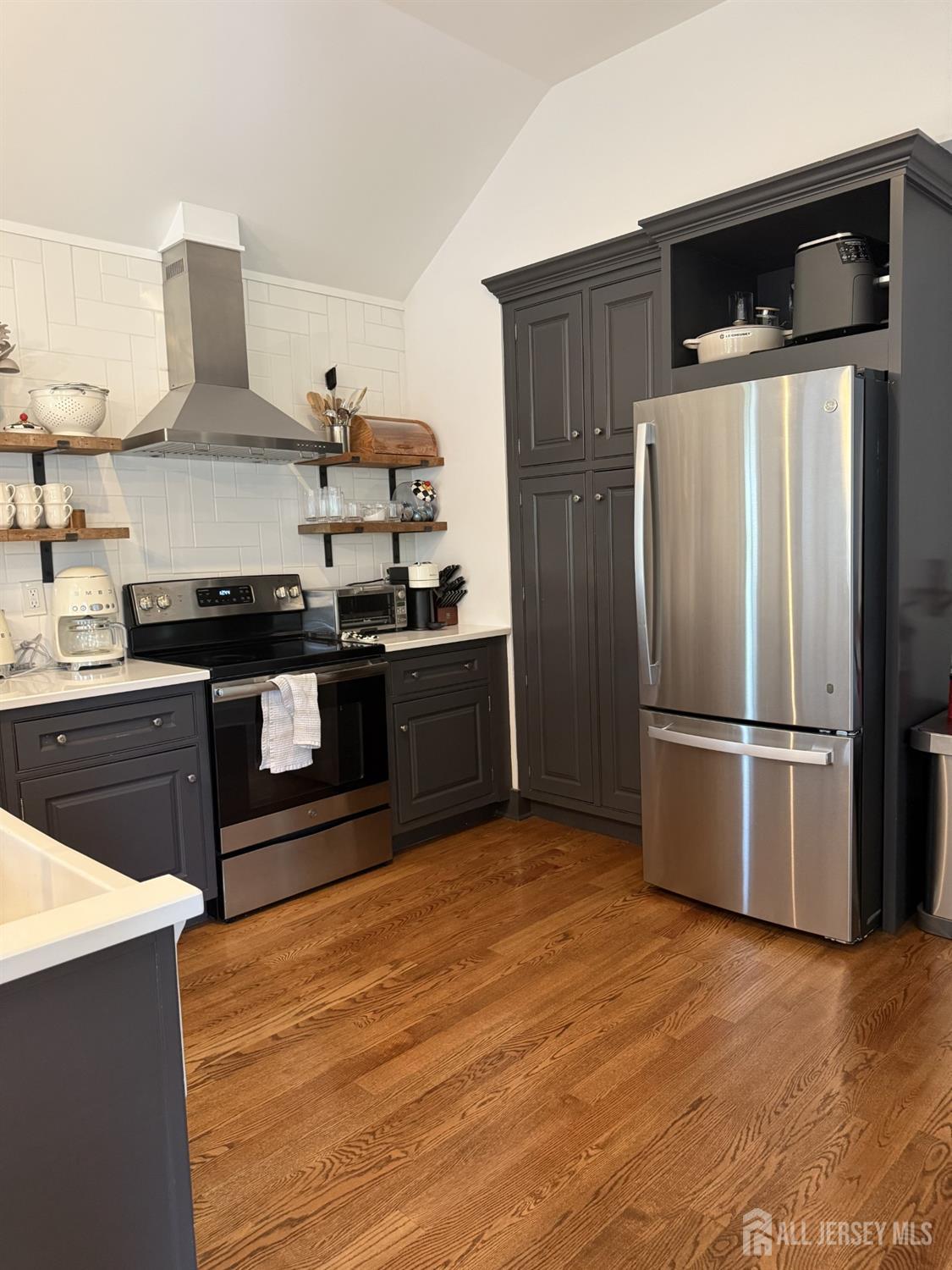 66 Main Street, Unit 3 Peapack, NJ 07977 - Photo 10 of 13 a kitchen with stainless steel appliances granite countertop a refrigerator and a stove