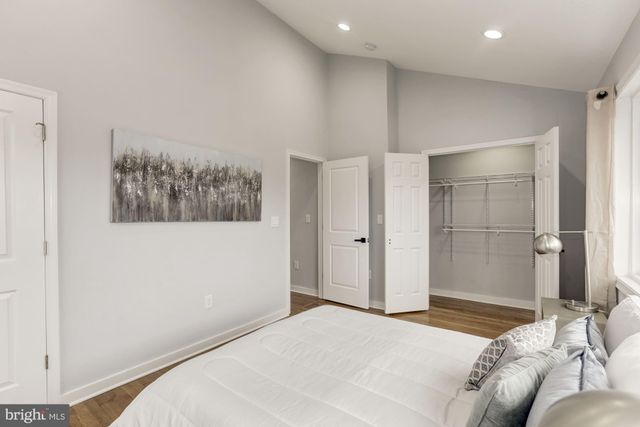 a bedroom with a bed and a painting