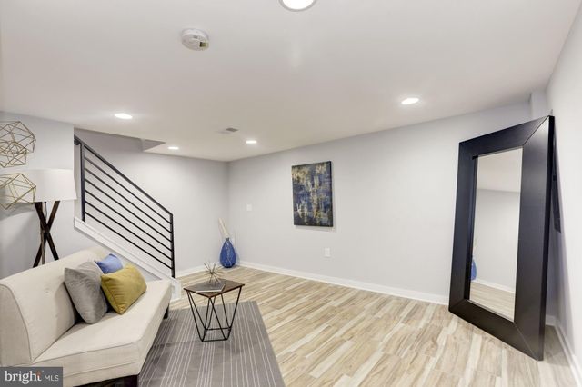 a hallway with a couch and wooden floor