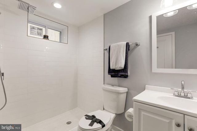 a bathroom with a sink toilet and mirror