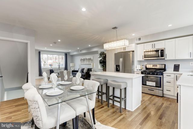 a view of kitchen with sink dining table and chairs