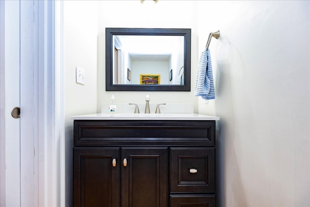 105 Green Street, Unit 4 Marblehead, MA 01945 - Photo 13 of 30 a bathroom with a sink vanity and a mirror