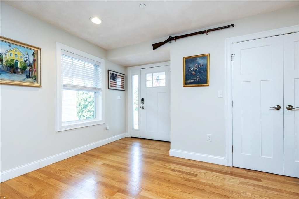 105 Green Street, Unit 4 Marblehead, MA 01945 - Photo 14 of 30 a view of an empty room with wooden floor and a window
