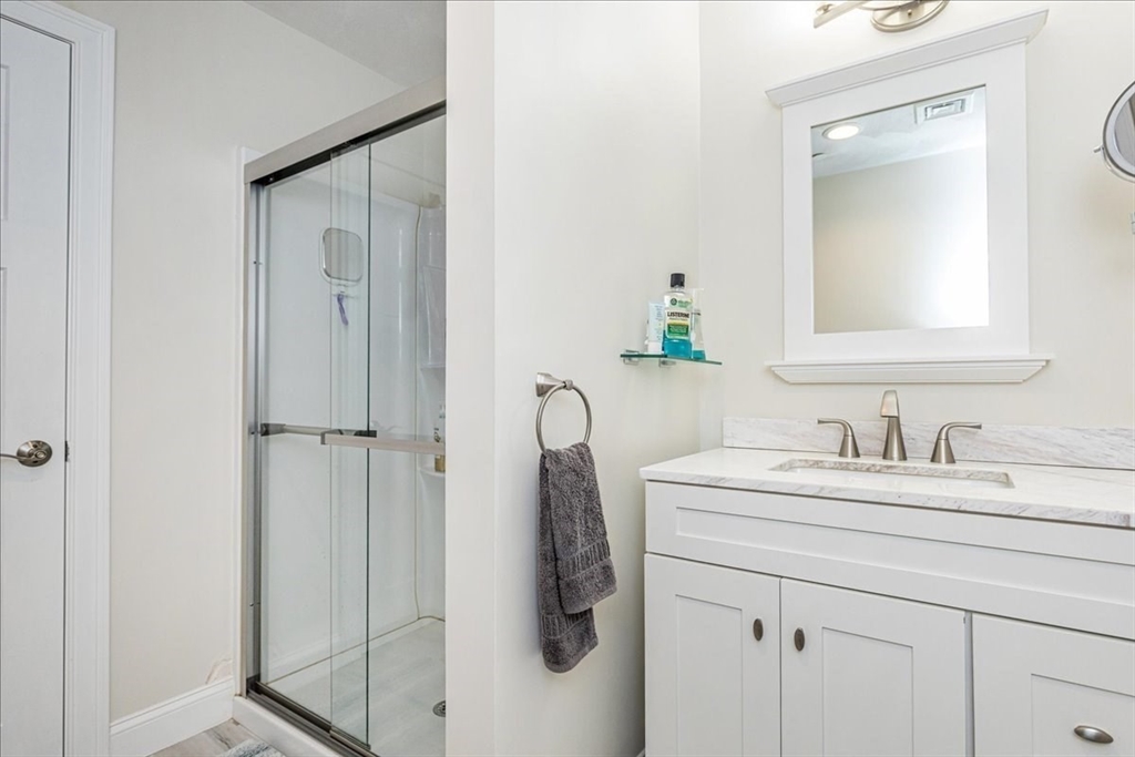 105 Green Street, Unit 4 Marblehead, MA 01945 - Photo 19 of 30 a bathroom with a sink vanity and mirror
