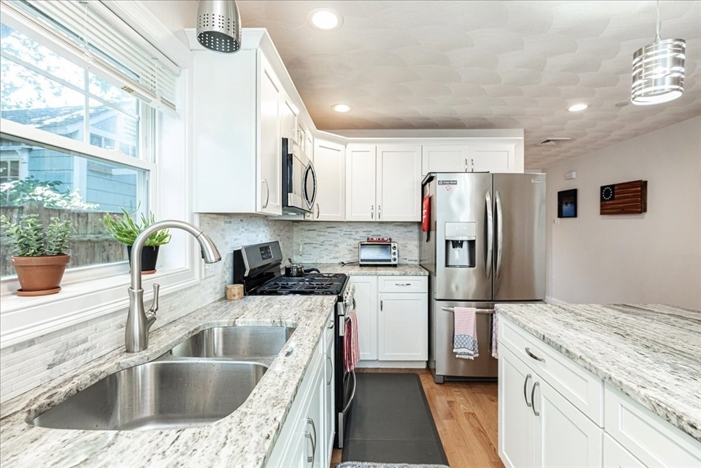 105 Green Street, Unit 4 Marblehead, MA 01945 - Photo 2 of 30 a kitchen with refrigerator cabinets and a sink