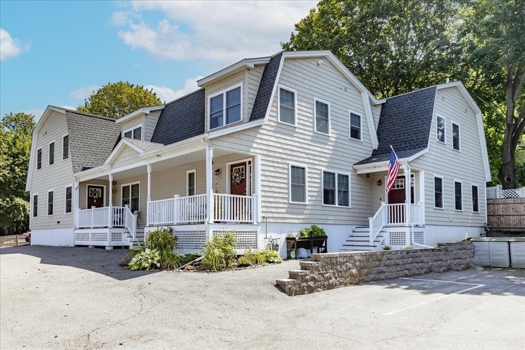 105 Green Street, Unit 4 Marblehead, MA 01945 - Photo 27 of 30 a front view of a house with a yard and potted plants