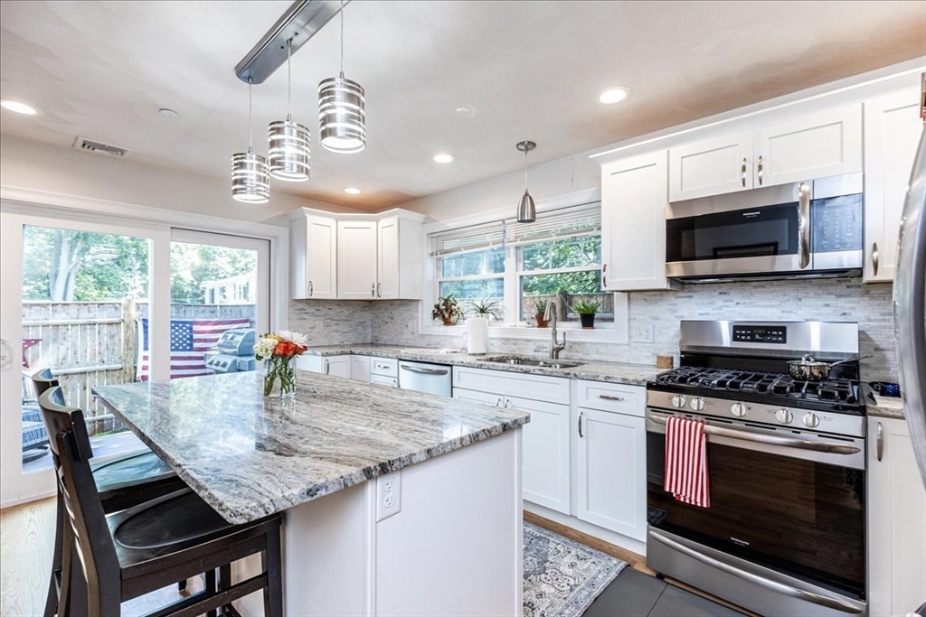105 Green Street, Unit 4 Marblehead, MA 01945 - Photo 3 of 30 a kitchen with a stove a sink and a microwave