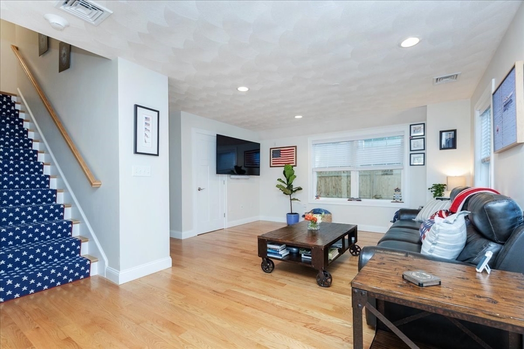 105 Green Street, Unit 4 Marblehead, MA 01945 - Photo 10 of 30 a living room with furniture and a flat screen tv