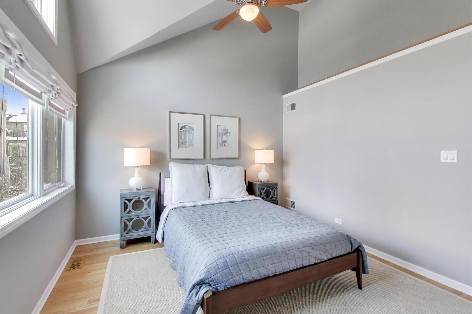 2737 North Janssen Avenue, Unit B Chicago, IL 60614 - Photo 20 of 31 a bedroom with a bed and a lamp next to a window