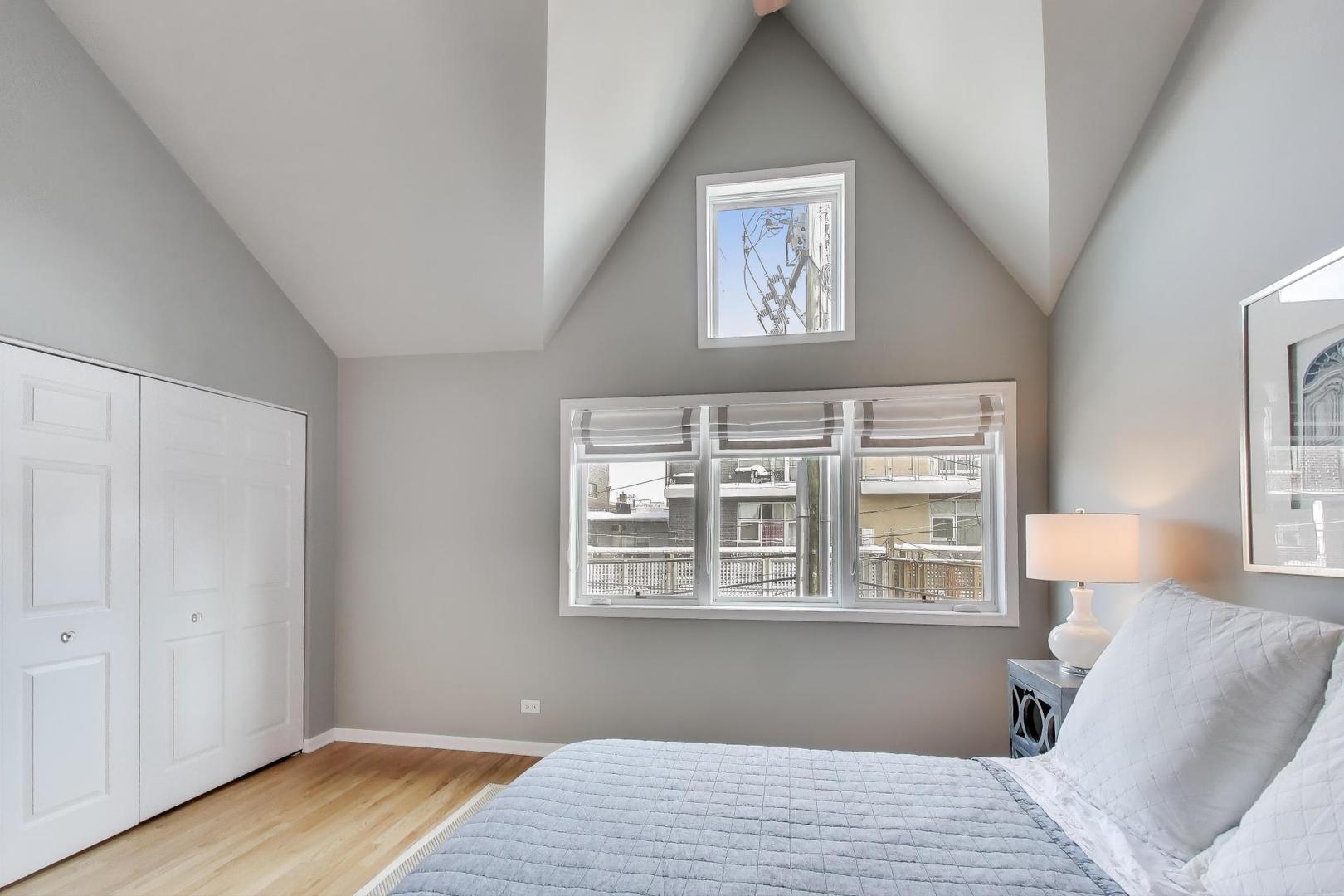 2737 North Janssen Avenue, Unit B Chicago, IL 60614 - Photo 21 of 31 a view of a bedroom with wooden floor and windows