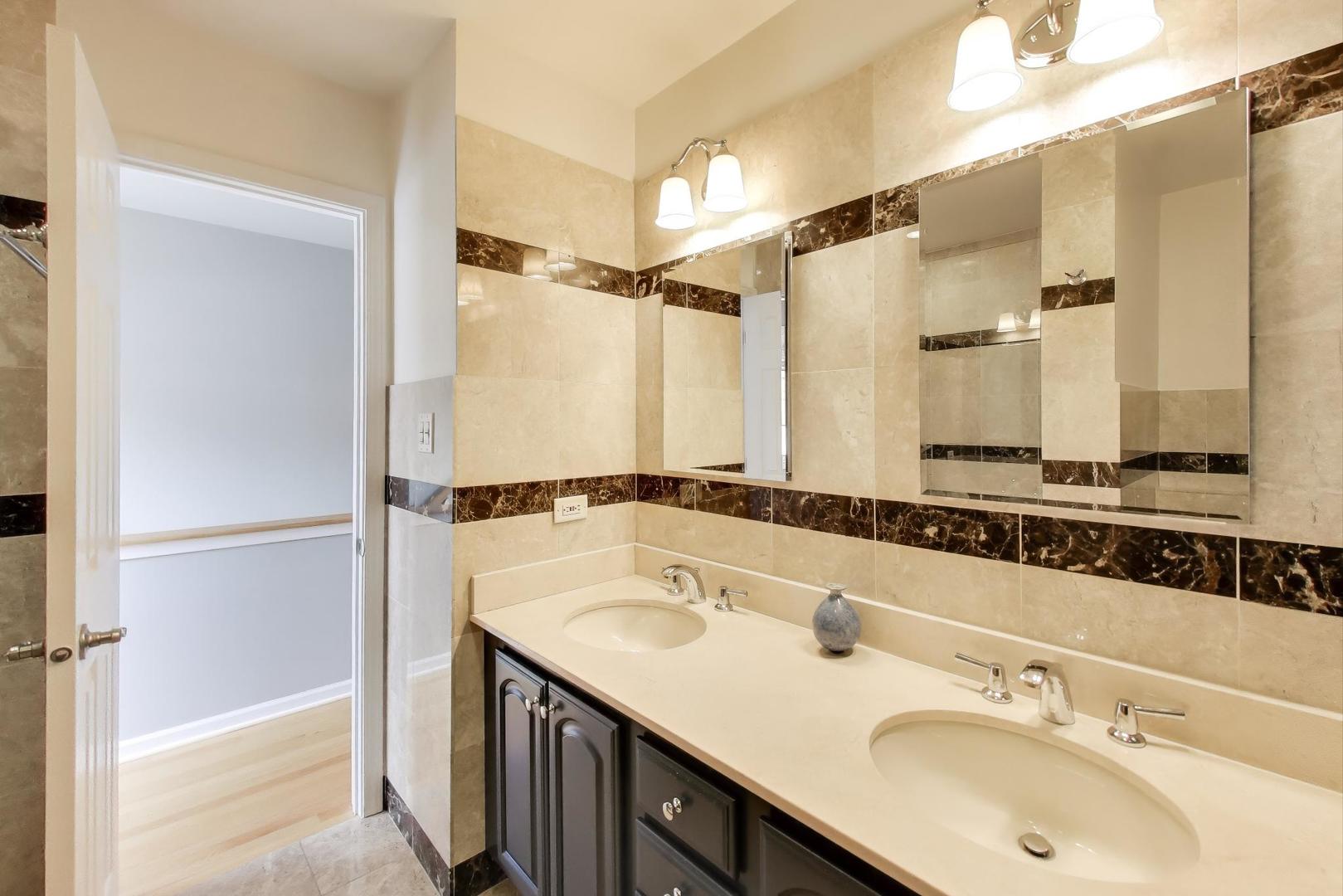 2737 North Janssen Avenue, Unit B Chicago, IL 60614 - Photo 23 of 31 a bathroom with a sink double vanity and a mirror